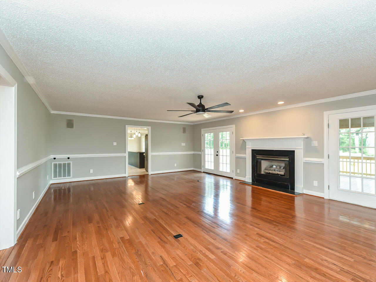 232 Mitchell Farm Road Goldsboro, NC 27530 - Photo 47 of 82 an empty room with wooden floor fireplace and windows