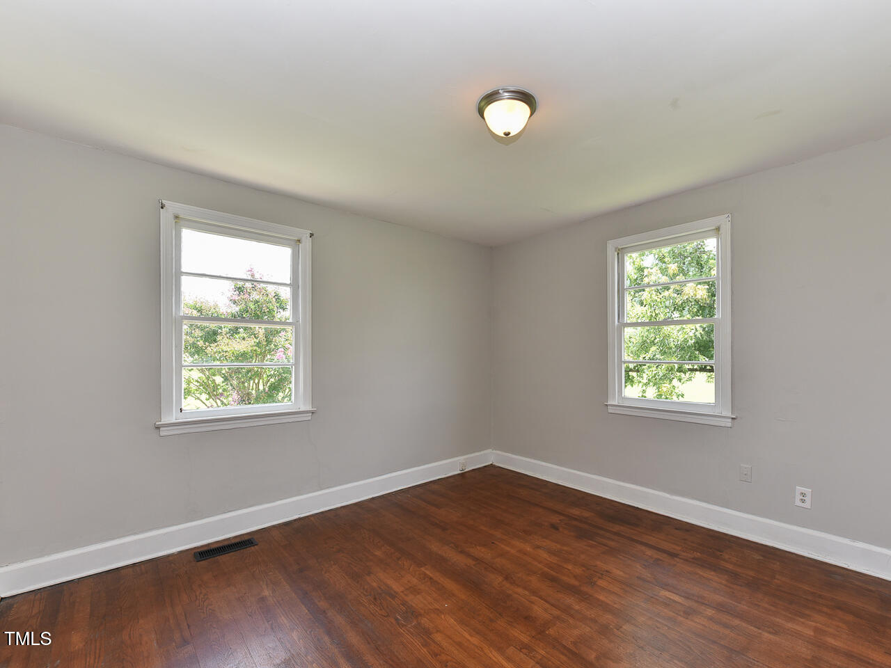 232 Mitchell Farm Road Goldsboro, NC 27530 - Photo 64 of 82 an empty room with wooden floor and windows