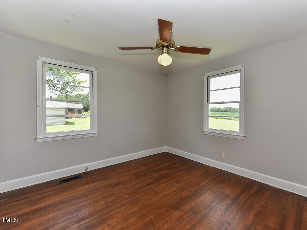 232 Mitchell Farm Road Goldsboro, NC 27530 - Photo 65 of 82 a view of empty room with wooden floor and fan