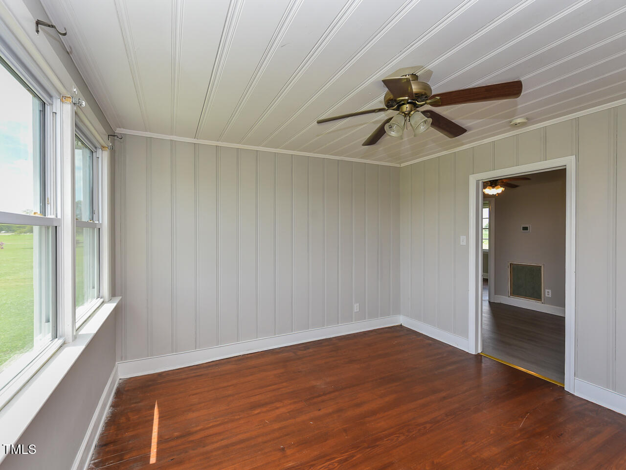 232 Mitchell Farm Road Goldsboro, NC 27530 - Photo 71 of 82 a view of empty room with wooden floor and fan