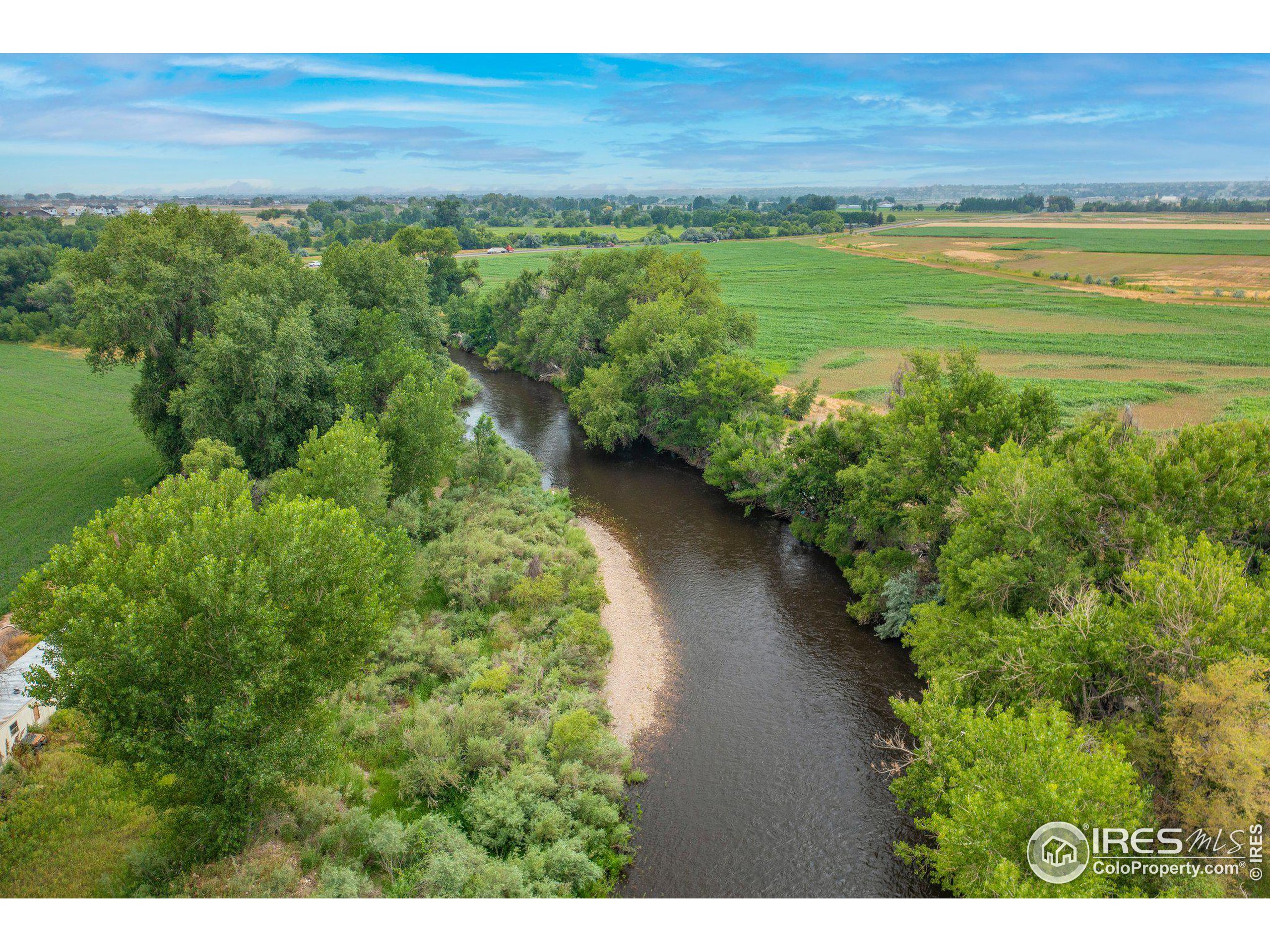 4801 East Harmony Road Fort Collins, CO 80528 - Photo 22 of 27 a view of a lake with a yard