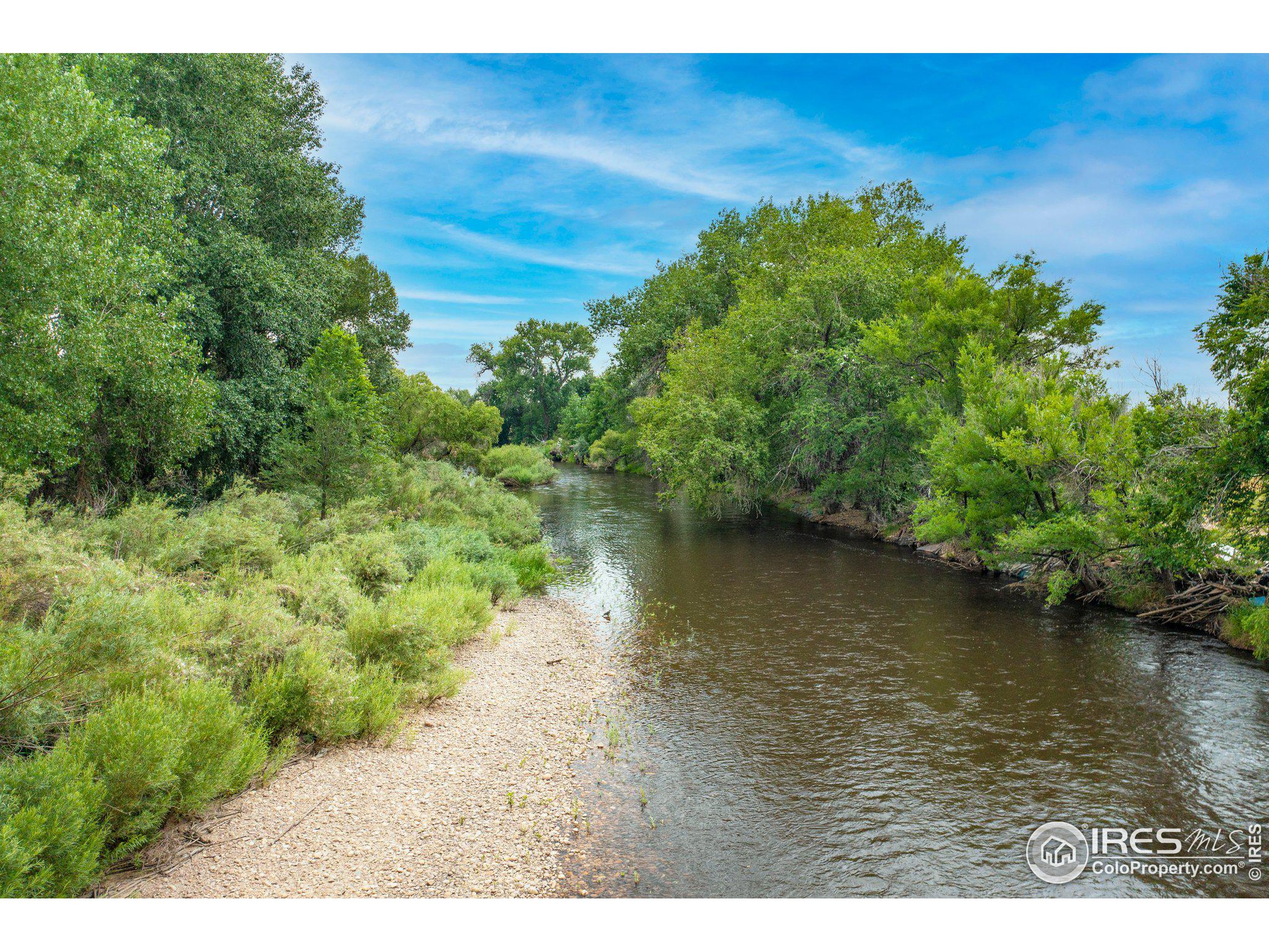 4801 East Harmony Road Fort Collins, CO 80528 - Photo 23 of 27 a view of a lake with beach and outdoor space