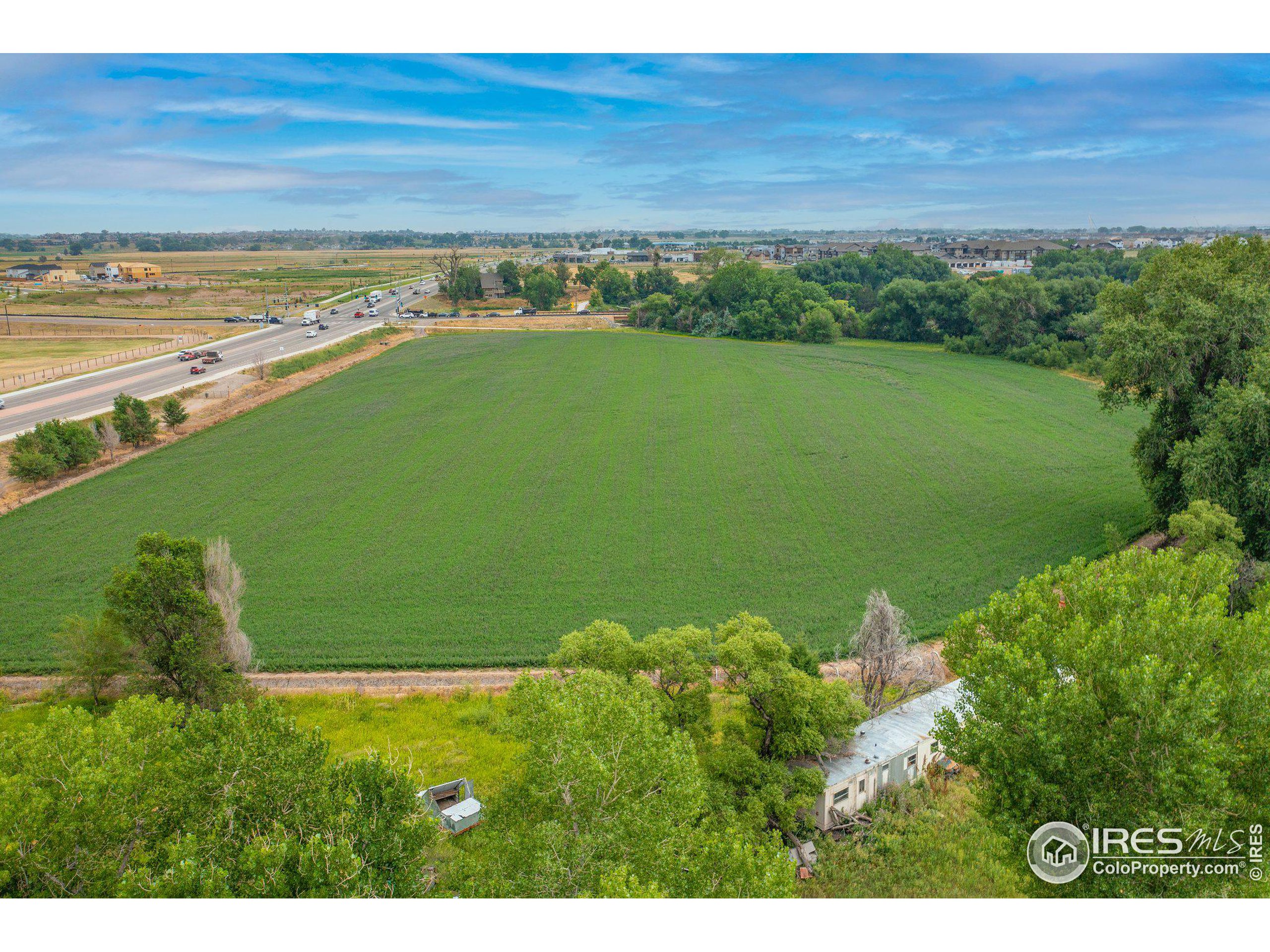 4801 East Harmony Road Fort Collins, CO 80528 - Photo 24 of 27 a view of a lake with a yard