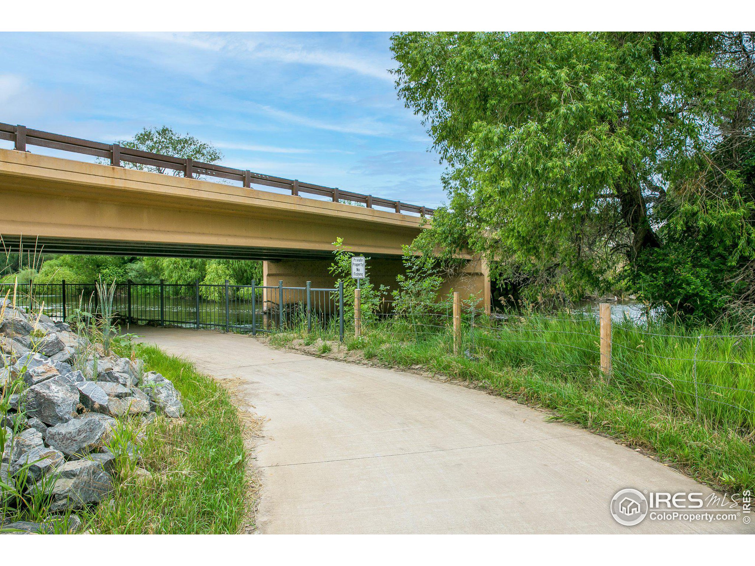 4801 East Harmony Road Fort Collins, CO 80528 - Photo 5 of 27 a view of a garden with a table and chairs under an umbrella