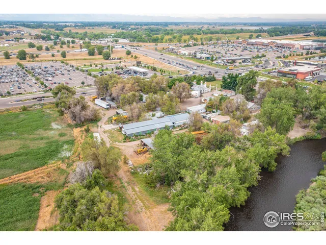 an aerial view of residential houses with outdoor space and trees