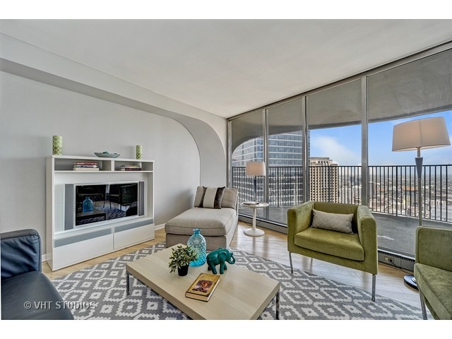 300 North State Street, Unit 5518 Chicago, IL 60654 - Photo 3 of 16 a living room with furniture and a fireplace