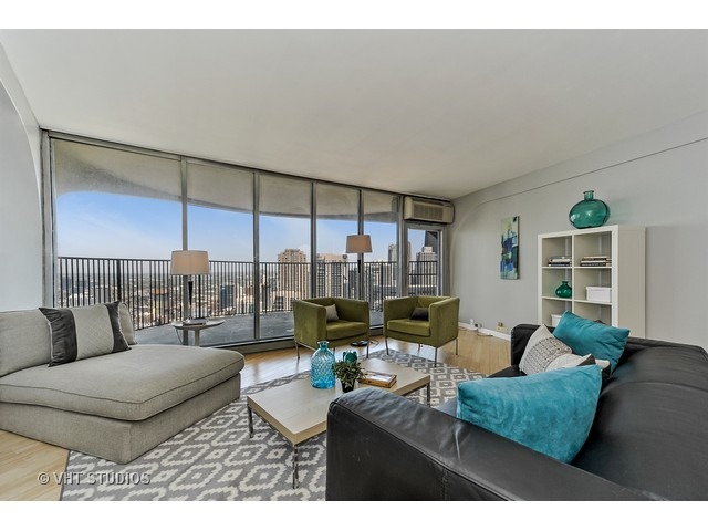300 North State Street, Unit 5518 Chicago, IL 60654 - Photo 4 of 16 a living room with furniture and a floor to ceiling window