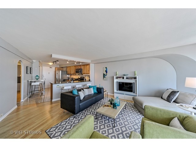 300 North State Street, Unit 5518 Chicago, IL 60654 - Photo 5 of 16 a living room with furniture and a fireplace