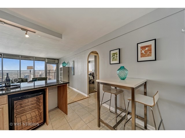 300 North State Street, Unit 5518 Chicago, IL 60654 - Photo 7 of 16 a view of a dining room kitchen with a table and chairs