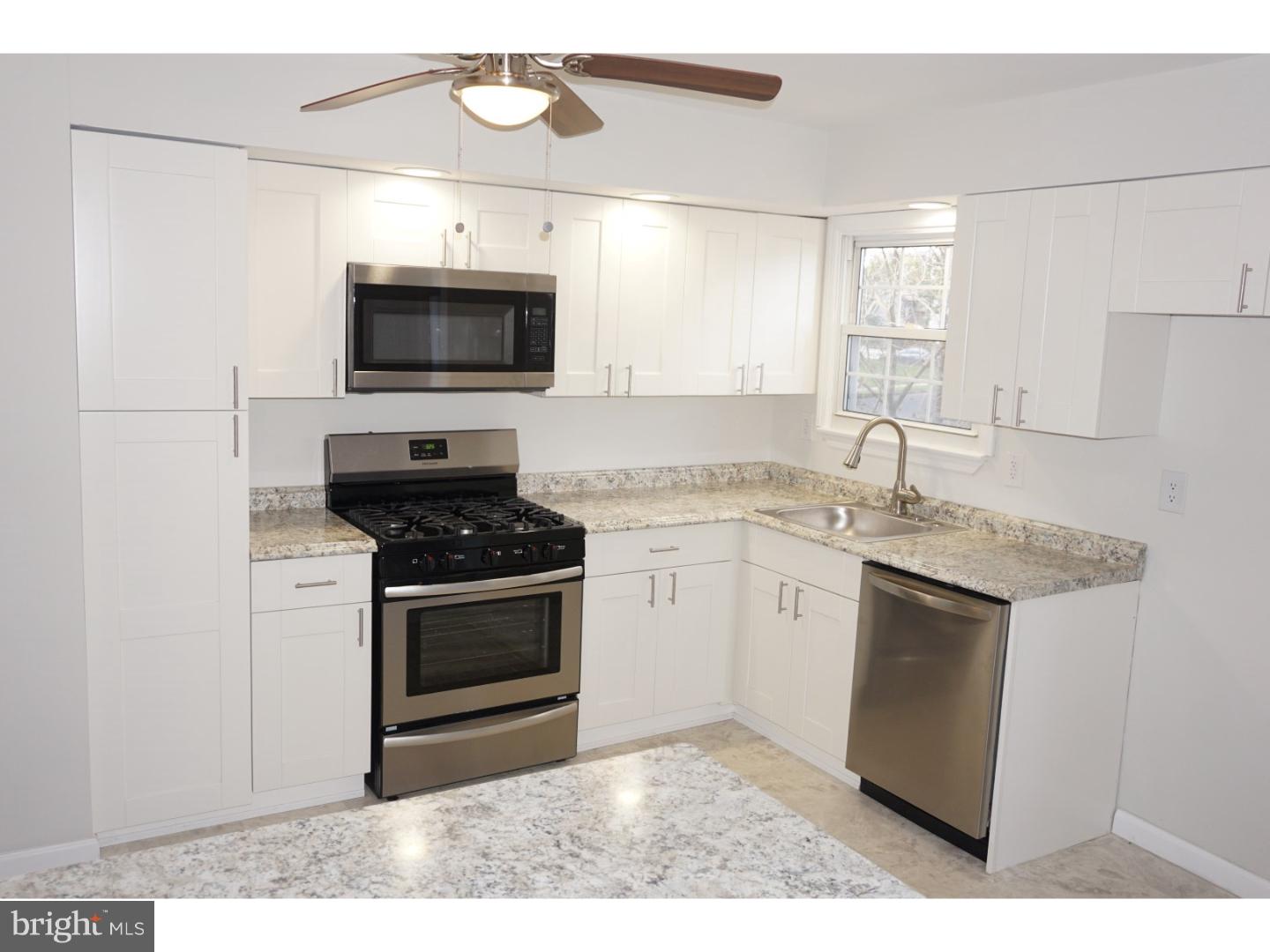 772 Lancing Road Deptford, NJ 08096 - Photo 7 of 24 a kitchen with a sink stove and microwave