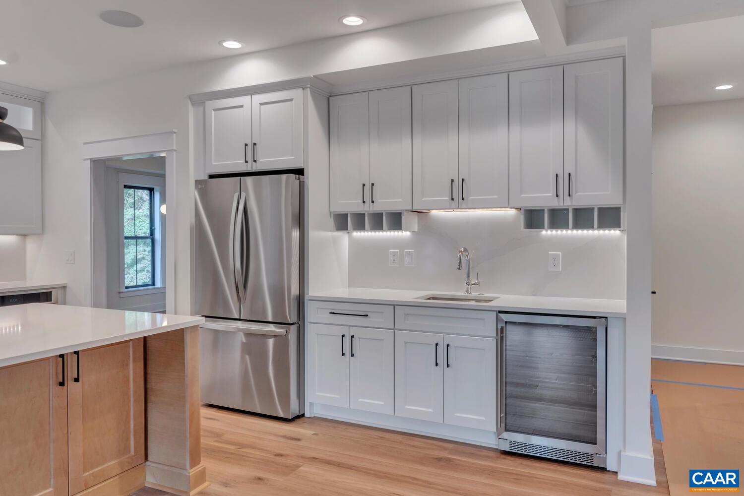 3 B Jarmans Gap Road, Unit LOT 3B JARMANS GAP Crozet, VA 22932 - Photo 12 of 39 a kitchen with kitchen island granite countertop wooden cabinets and refrigerator