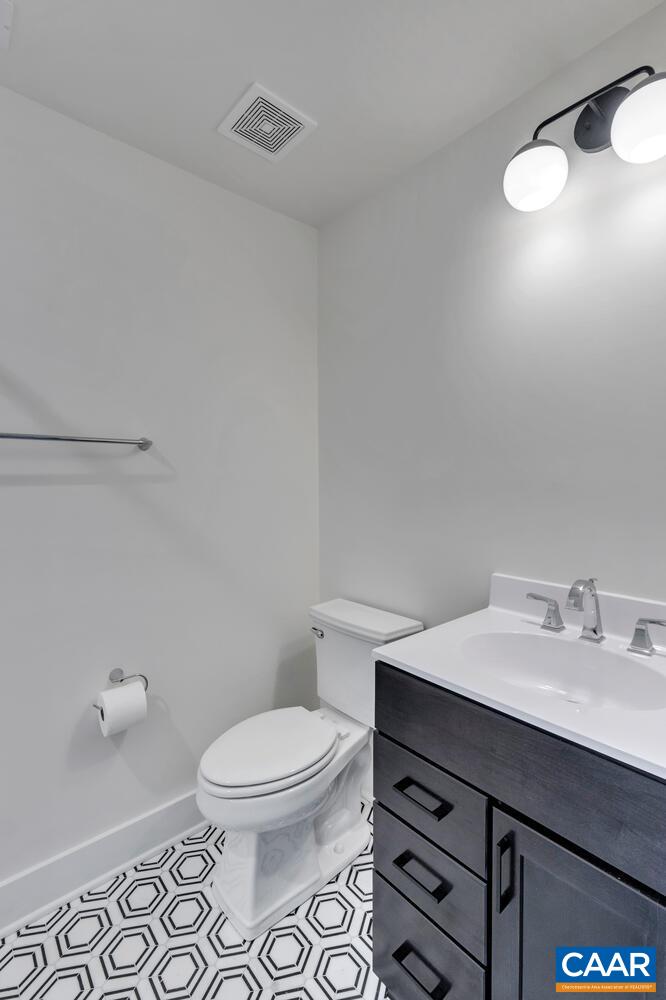 3 B Jarmans Gap Road, Unit LOT 3B JARMANS GAP Crozet, VA 22932 - Photo 29 of 39 a bathroom with a sink mirror vanity and toilet