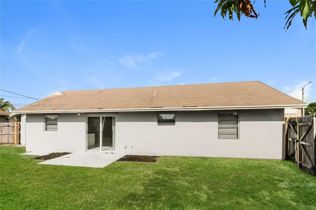 a backyard of a house with table and chairs