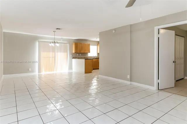 a view of a kitchen with a sink and a refrigerator