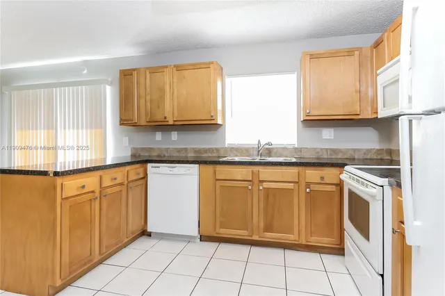 a kitchen with granite countertop cabinets and steel stainless steel appliances