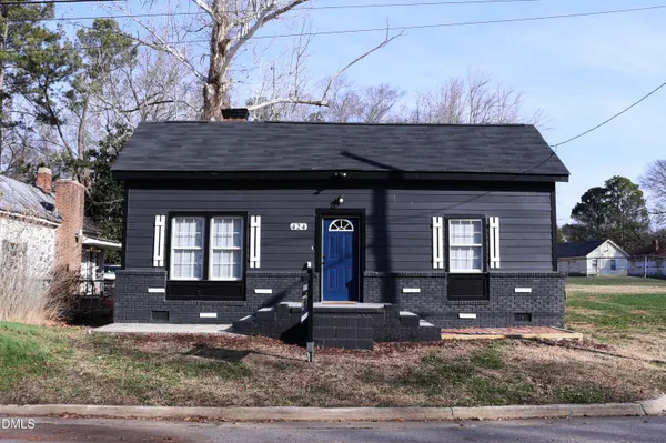 a view of a house with a small yard
