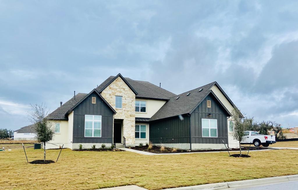 270 Prairie Clover Drive Dripping Springs, TX 78620 - Photo 1 of 28 View of front of home with board and batten siding, a front yard, and a shingled roof