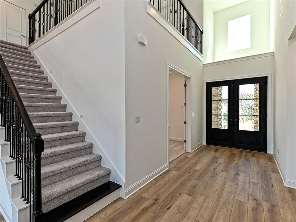270 Prairie Clover Drive Dripping Springs, TX 78620 - Photo 2 of 28 Foyer entrance featuring a high ceiling, healthy amount of natural light, light wood-type flooring, and french doors