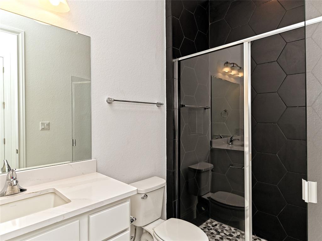 270 Prairie Clover Drive Dripping Springs, TX 78620 - Photo 23 of 28 Bathroom with vanity, a textured wall, and a shower stall