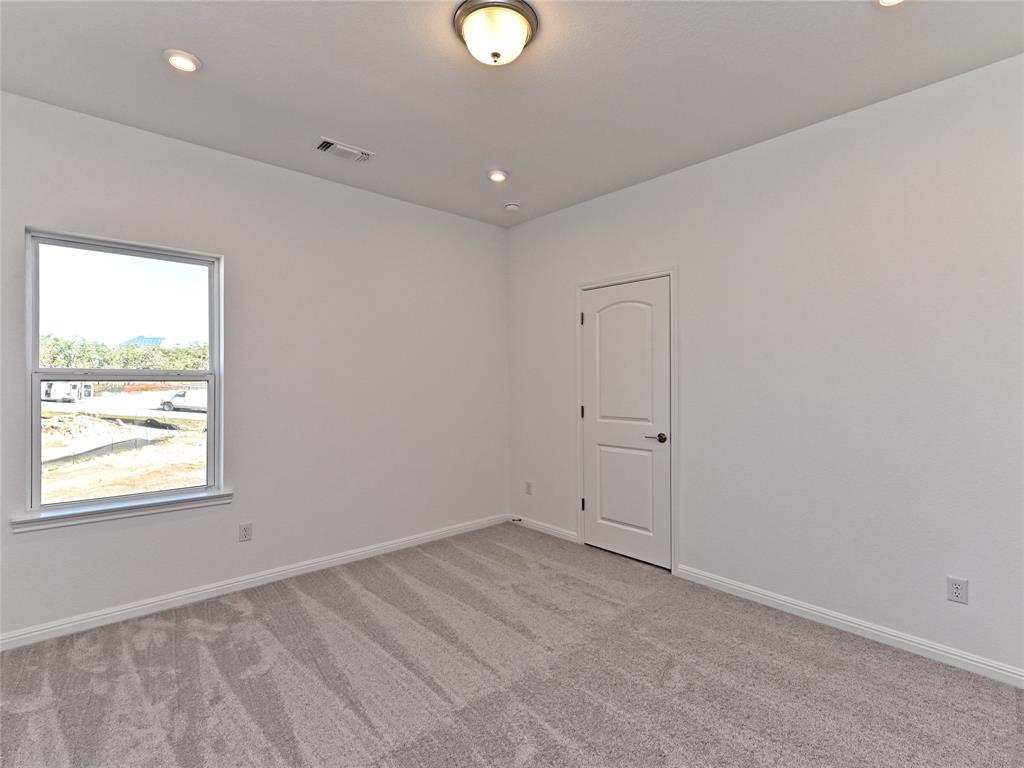 270 Prairie Clover Drive Dripping Springs, TX 78620 - Photo 26 of 28 Unfurnished room with light carpet and recessed lighting