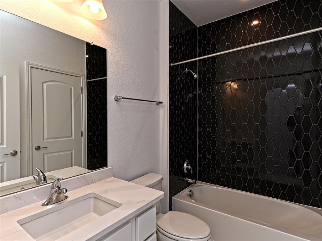 270 Prairie Clover Drive Dripping Springs, TX 78620 - Photo 27 of 28 Full bath with vanity, a textured wall, and tub / shower combination