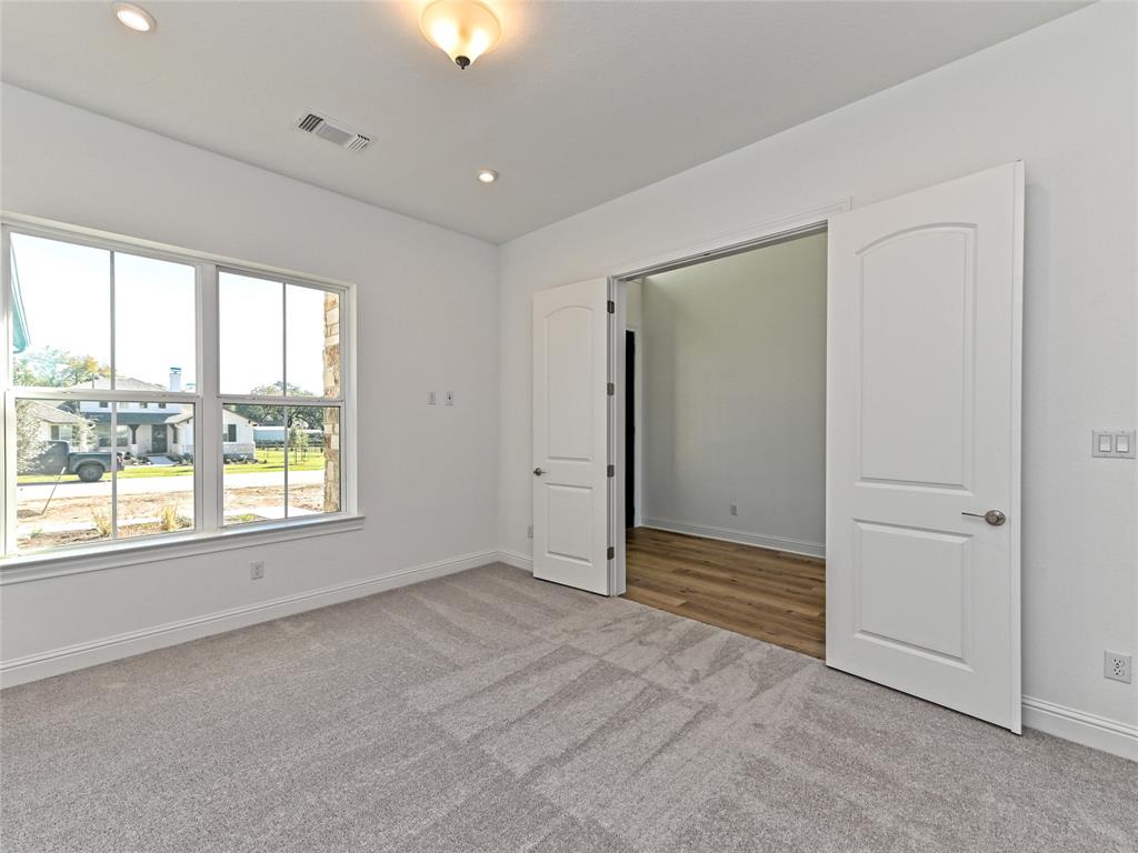 270 Prairie Clover Drive Dripping Springs, TX 78620 - Photo 4 of 28 Unfurnished bedroom with light colored carpet and recessed lighting
