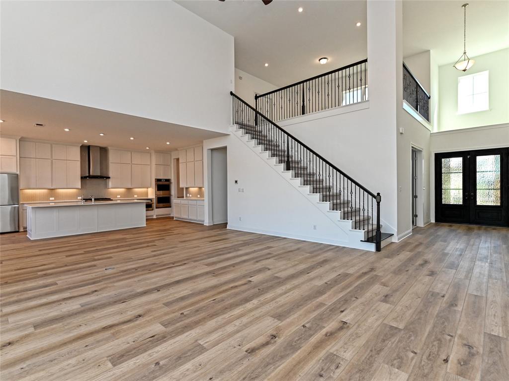 270 Prairie Clover Drive Dripping Springs, TX 78620 - Photo 7 of 28 Unfurnished living room featuring a high ceiling, french doors, light wood-style floors, recessed lighting, and a ceiling fan