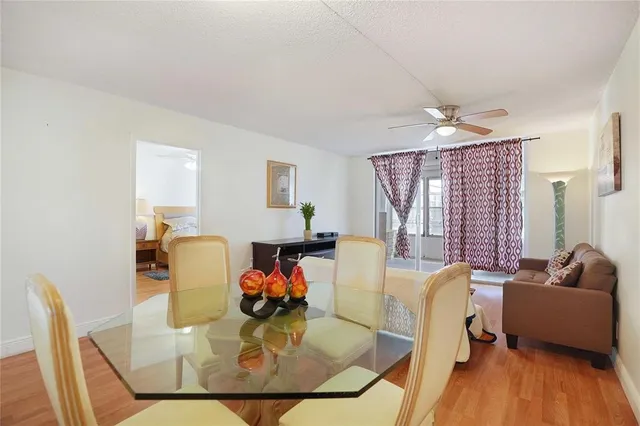 a view of a dining room with furniture a chandelier and wooden floor