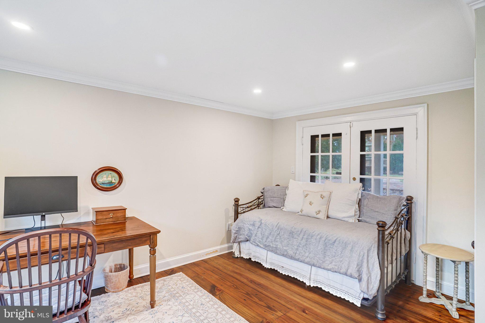 7153 Main Street Clifton, VA 20124 - Photo 11 of 77 a bedroom with a bed and a lamp with the wooden floor
