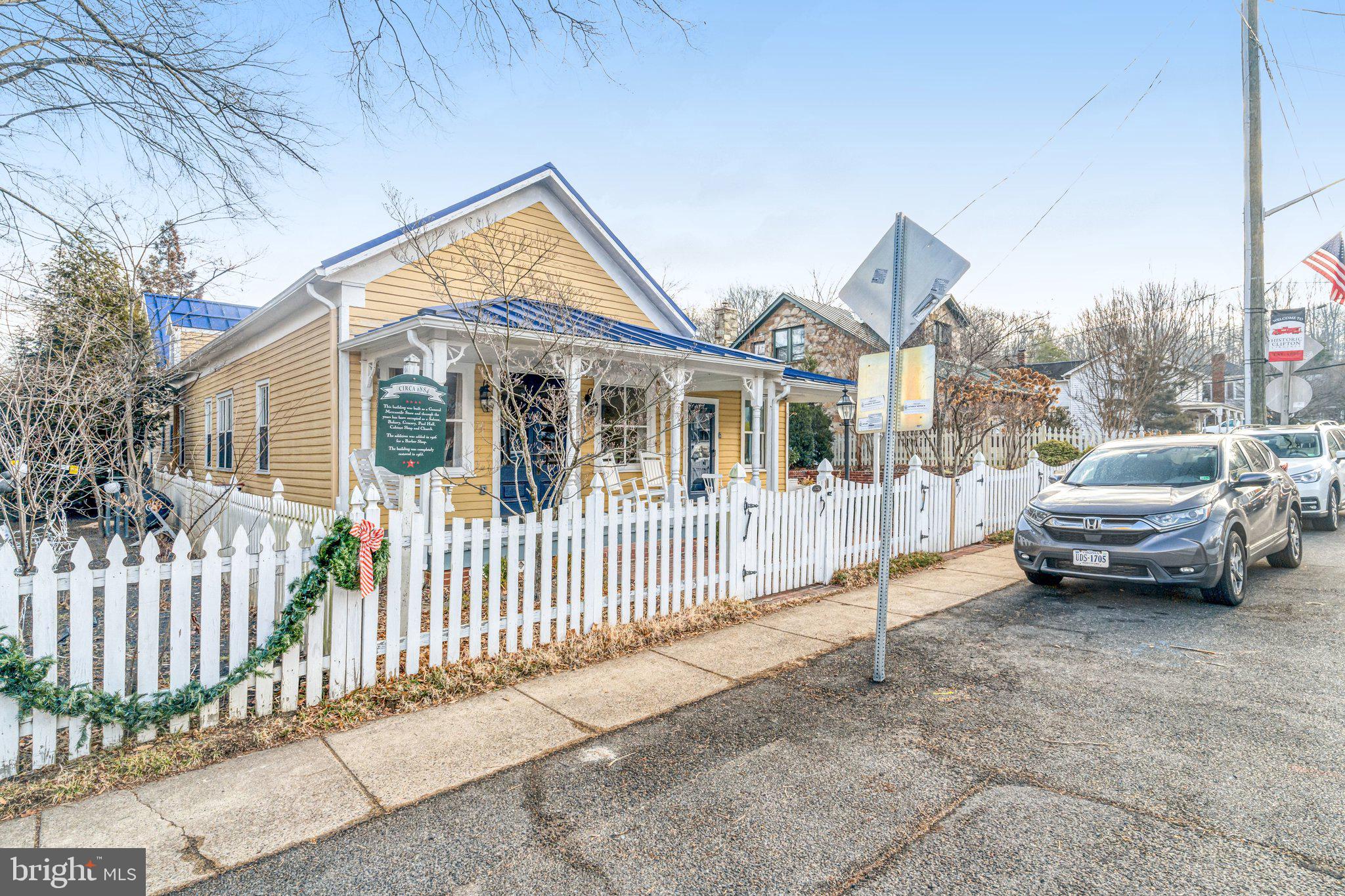 7153 Main Street Clifton, VA 20124 - Photo 2 of 77 a view of a house with a car park side of a road