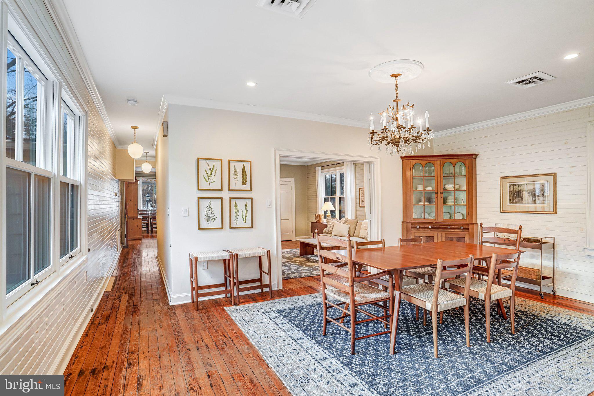 7153 Main Street Clifton, VA 20124 - Photo 27 of 77 a view of a dining room with furniture a chandelier and wooden floor