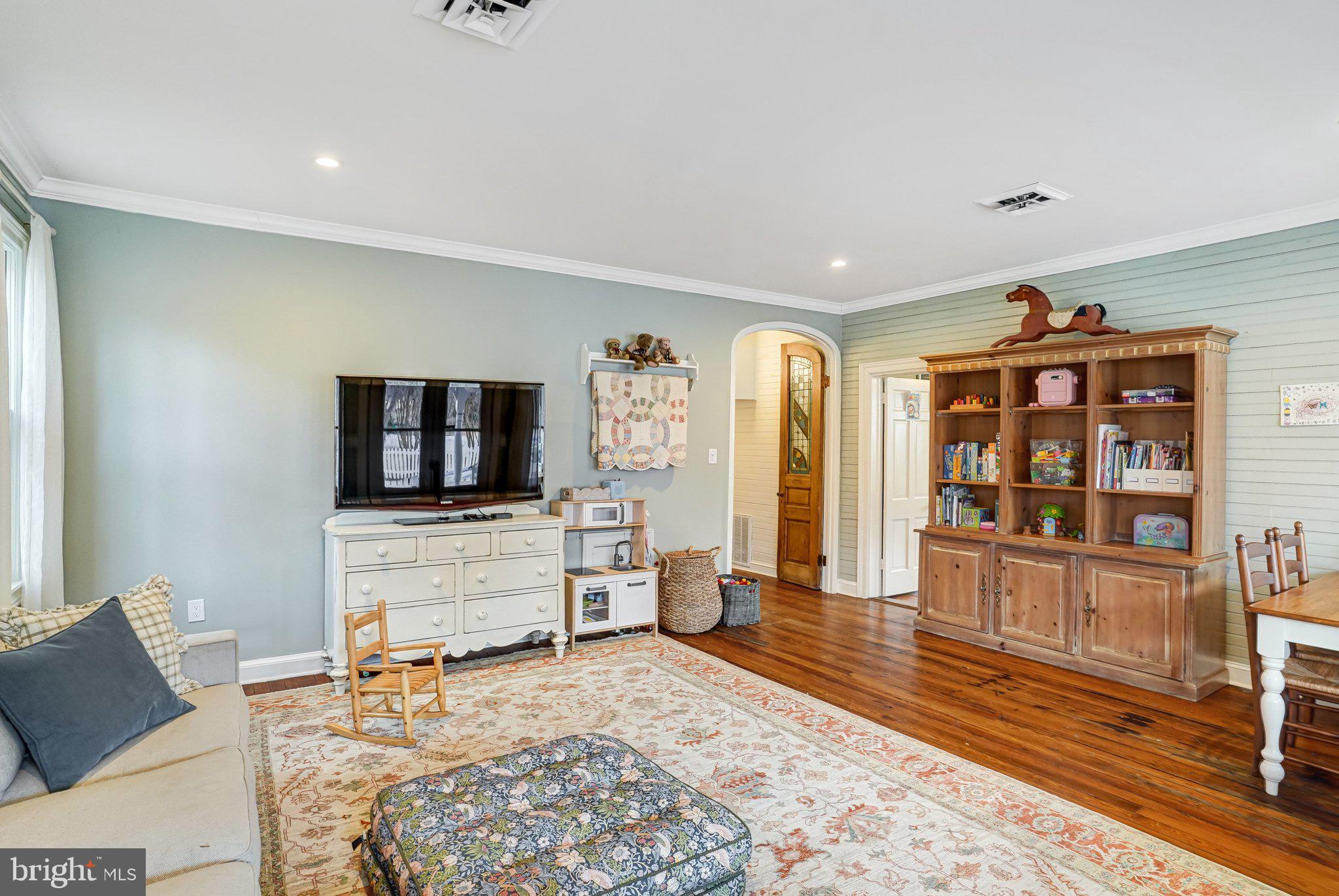 7153 Main Street Clifton, VA 20124 - Photo 38 of 77 a living room with furniture and a flat screen tv