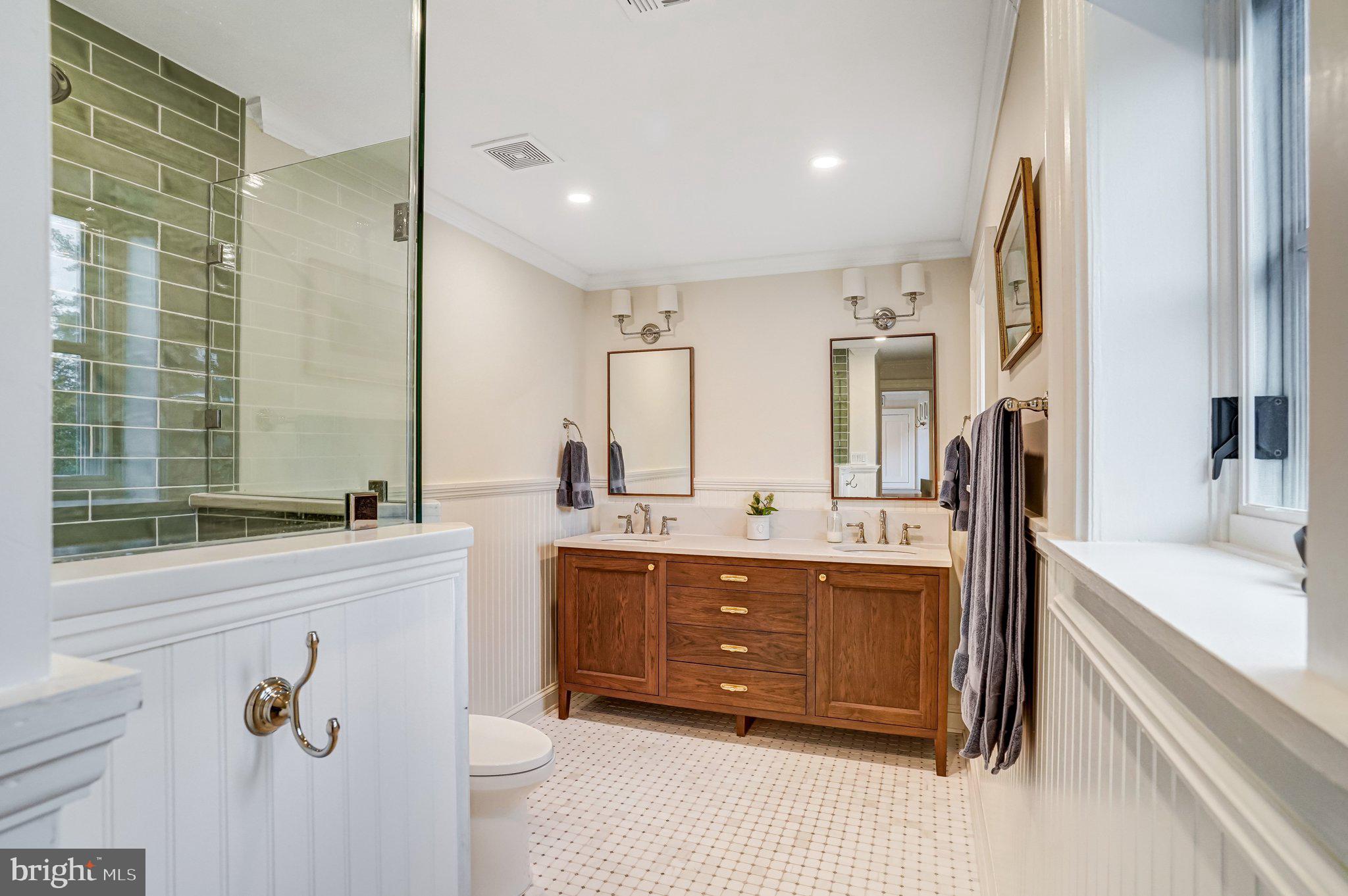7153 Main Street Clifton, VA 20124 - Photo 49 of 77 a spacious bathroom with a tub sink and mirror