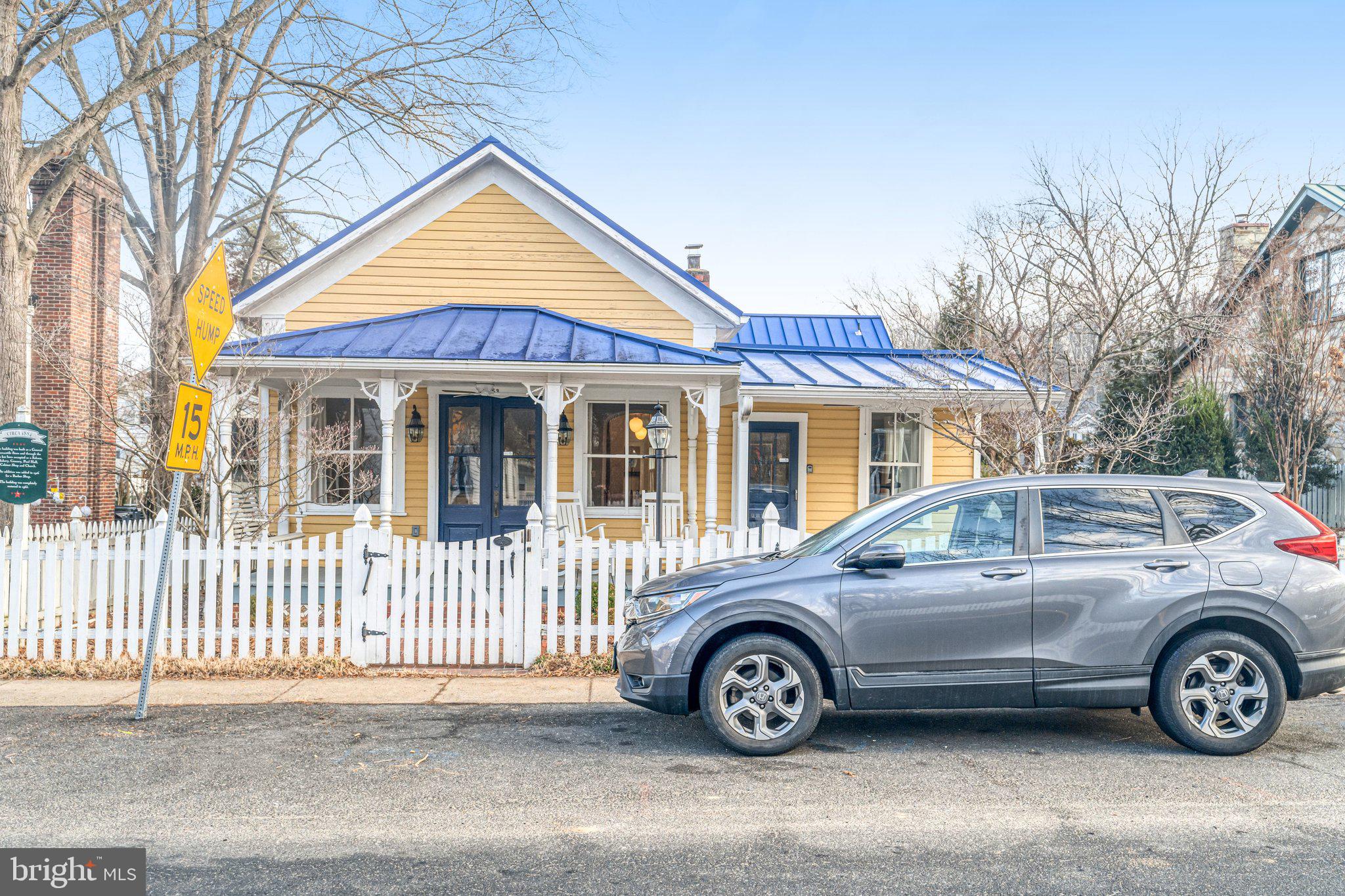 7153 Main Street Clifton, VA 20124 - Photo 6 of 77 a view of a car parked in front of a house