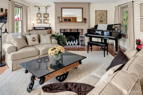a living room with furniture a fireplace and potted plants