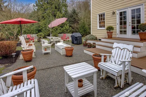 a view of a patio with a dining table and chairs