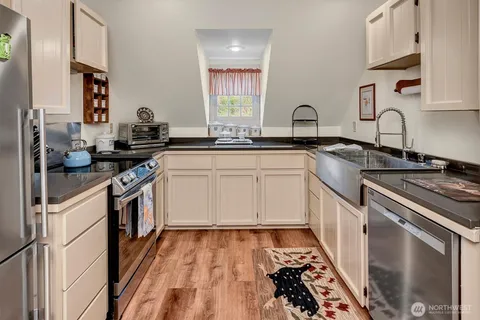 a kitchen with a sink stove and cabinets
