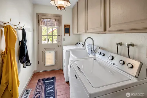 a utility room with closet dryer and washer