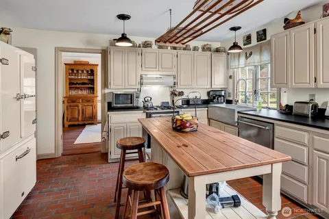 a kitchen with sink cabinets and wooden floor