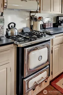 a stove top oven sitting inside of a kitchen