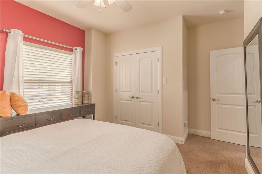 6708 Menchaca Road, Unit 14 Austin, TX 78745 - Photo 9 of 22 Room featuring a window with blinds, a ceiling fan, and carpeted flooring