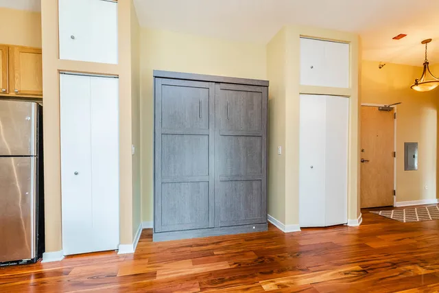 a view of a room with wooden floor and windows