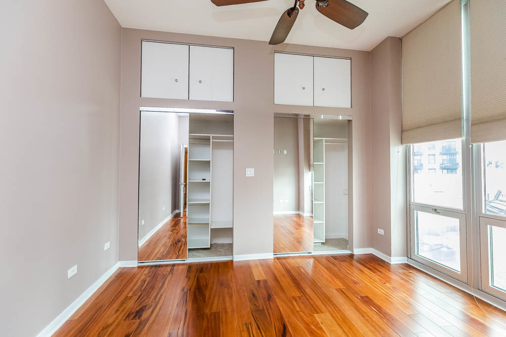 1600 South Indiana Avenue, Unit 501 Chicago, IL 60616 - Photo 25 of 29 a view of a room with wooden floor and windows