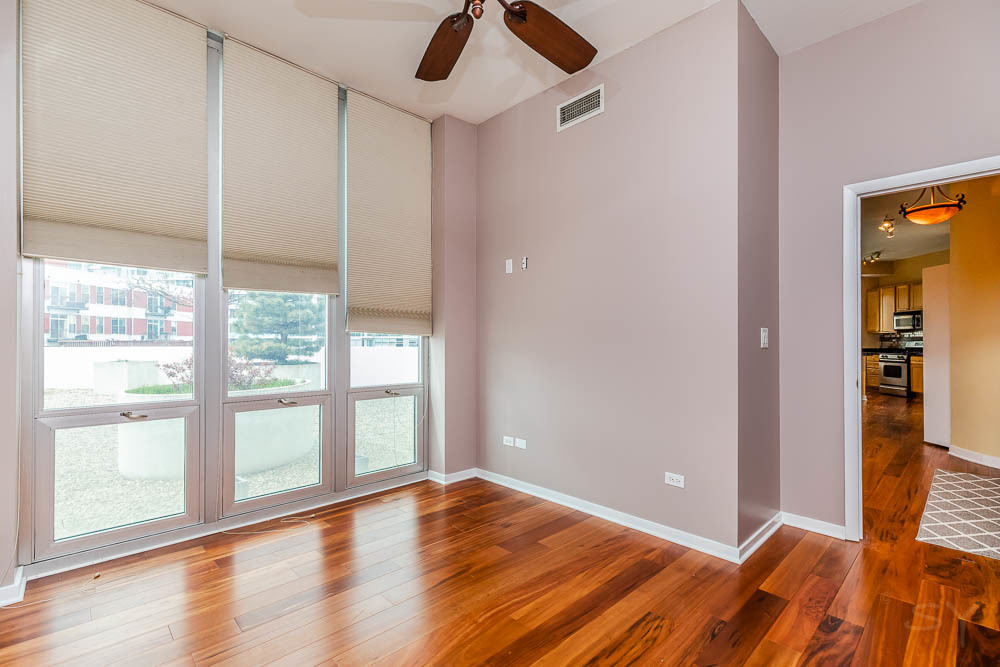 1600 South Indiana Avenue, Unit 501 Chicago, IL 60616 - Photo 27 of 29 a view of room with window and wooden floor