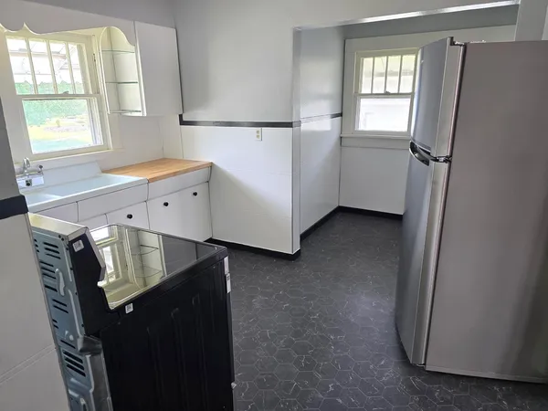 a view of walk in closet with window and refrigerator