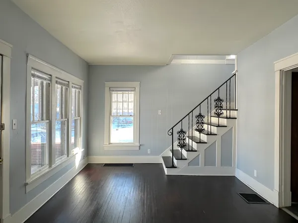 a view of an entryway with wooden floor
