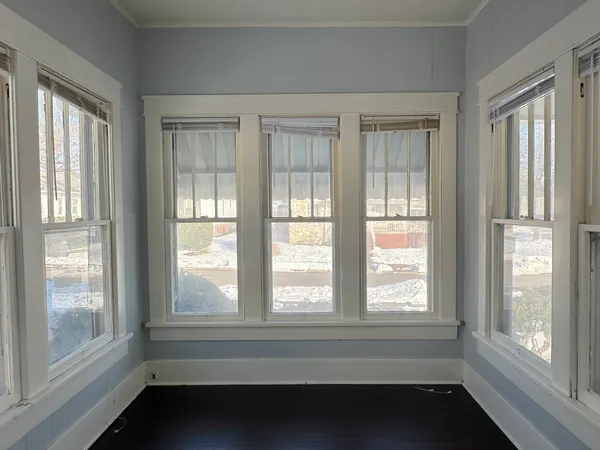 a view of empty room with windows and pool