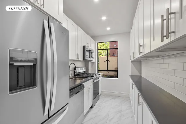 a kitchen with stainless steel appliances a refrigerator sink and stove