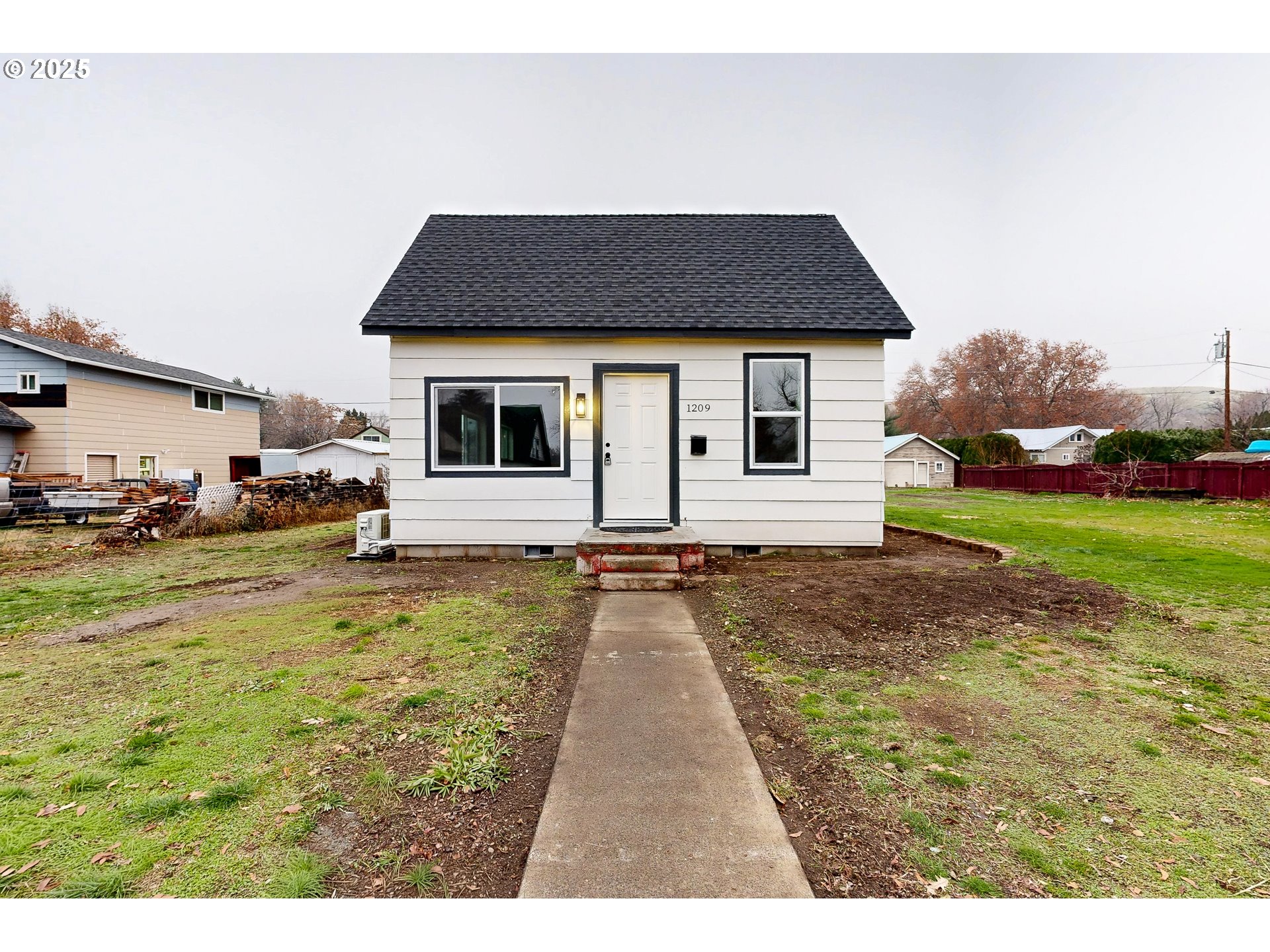 a view of house with yard and car parked