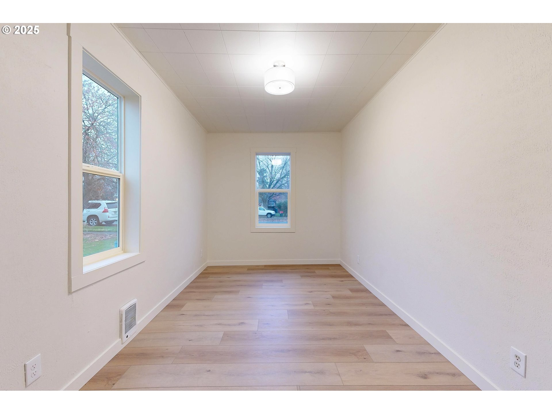 1209 Chestnut Street Milton Freewater, OR 97862 - Photo 12 of 23 an empty room with wooden floor and windows